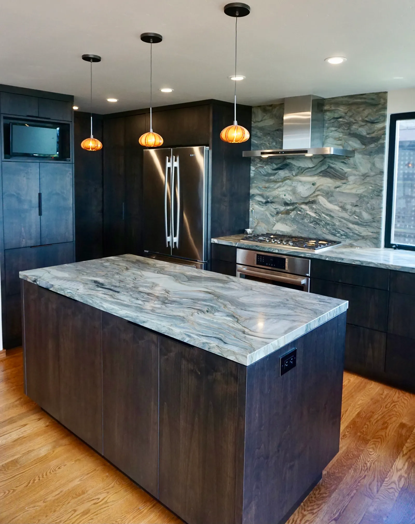 Veined marble kitchen island with pendant lights