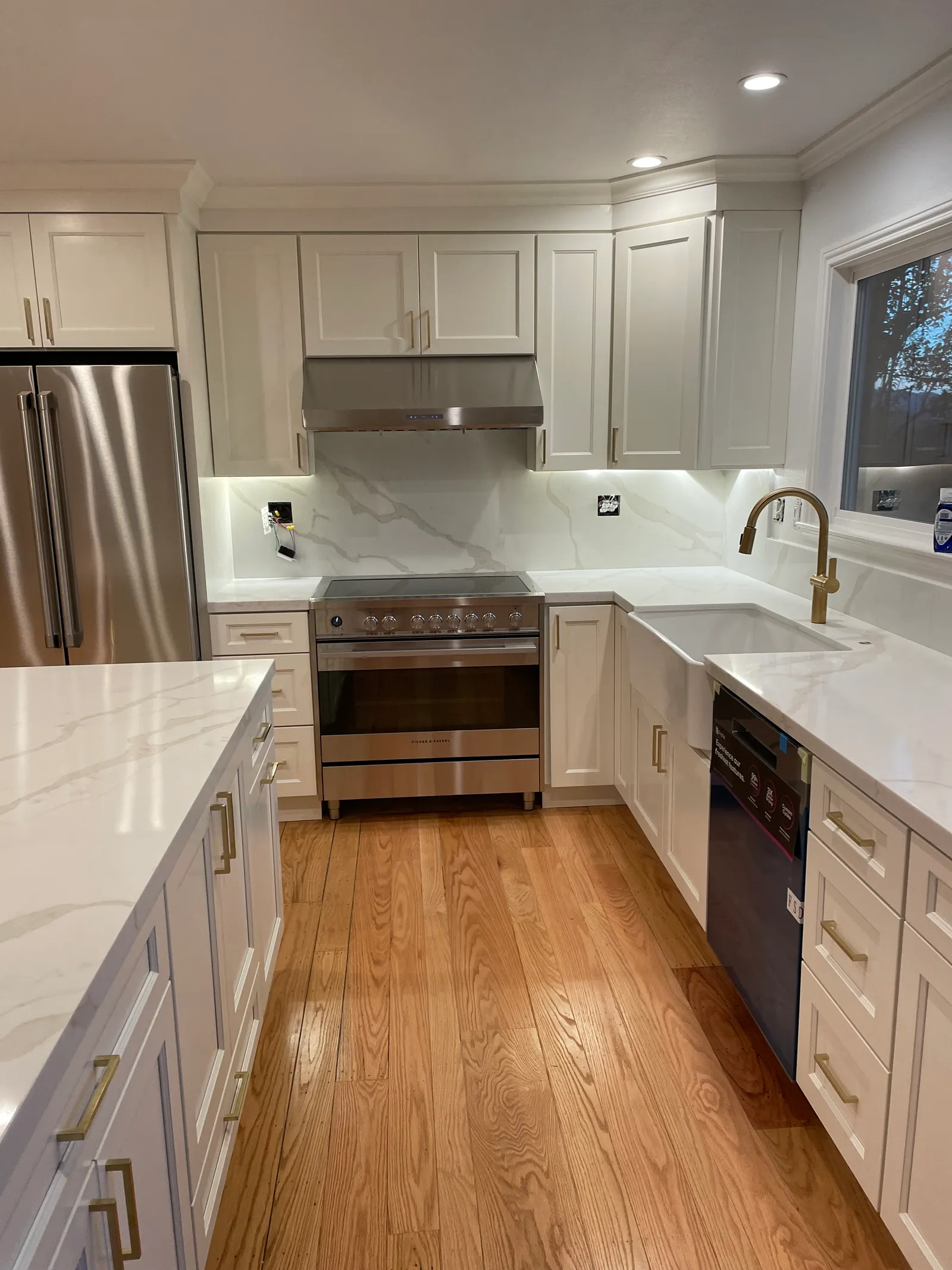 White shaker kitchen with quartz waterfall island